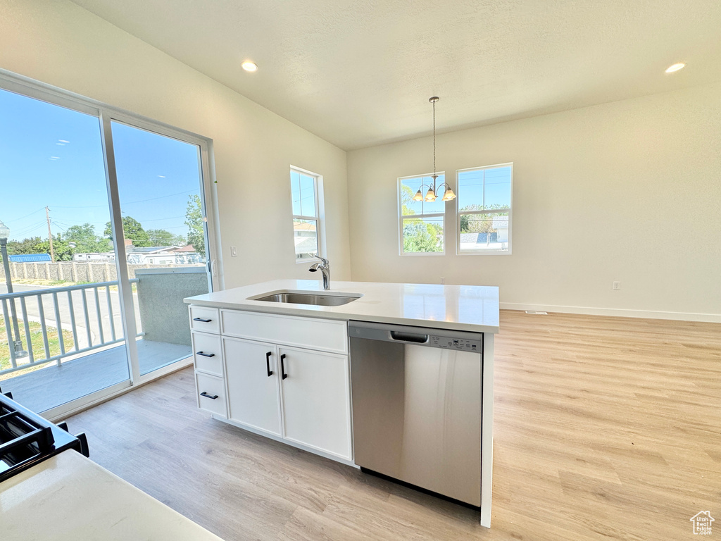 Kitchen featuring dishwasher, light wood finished floors, a chandelier, plenty of natural light, and recessed lighting