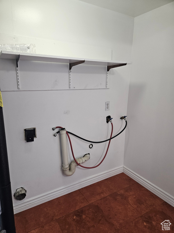 Washroom with washer hookup and tile patterned flooring