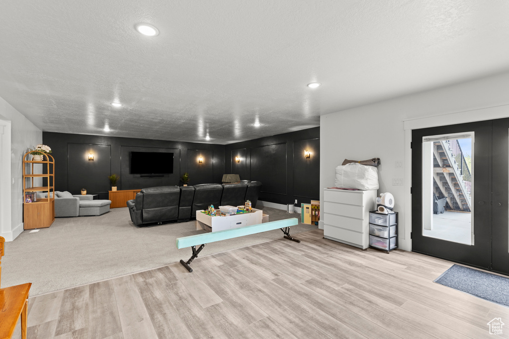 Living area featuring wood finished floors and recessed lighting