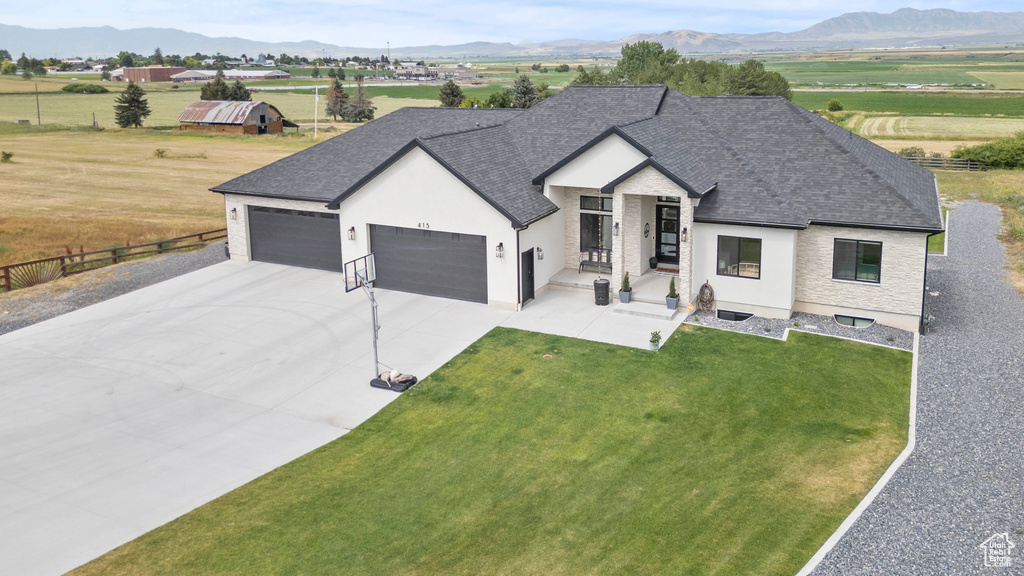 View of front of property featuring an attached garage, roof with shingles, stucco siding, and driveway
