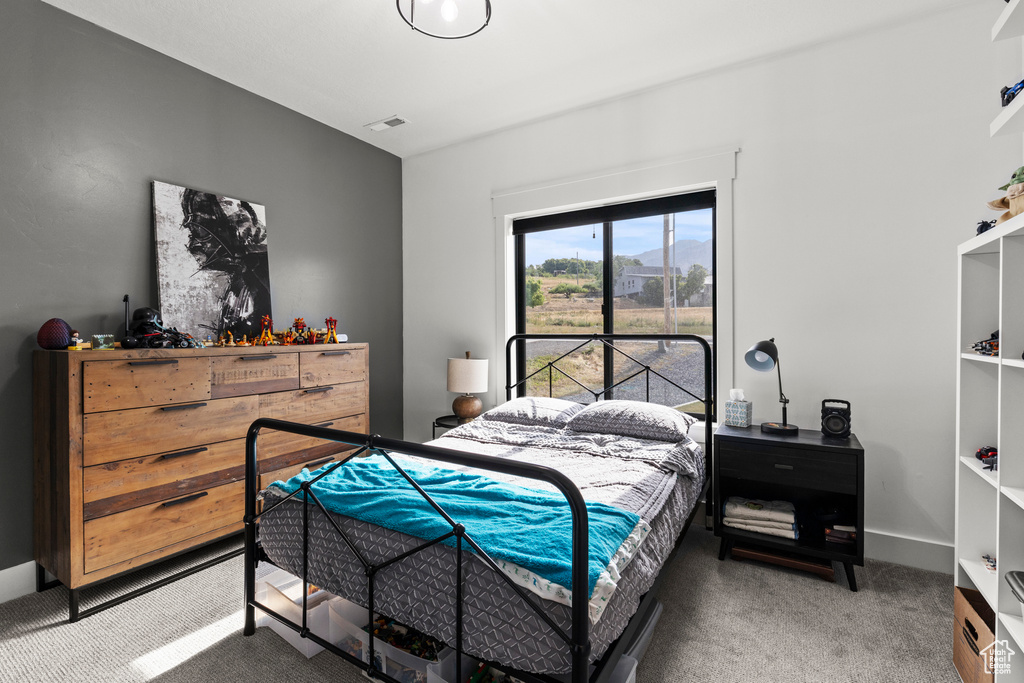 Carpeted bedroom featuring baseboards
