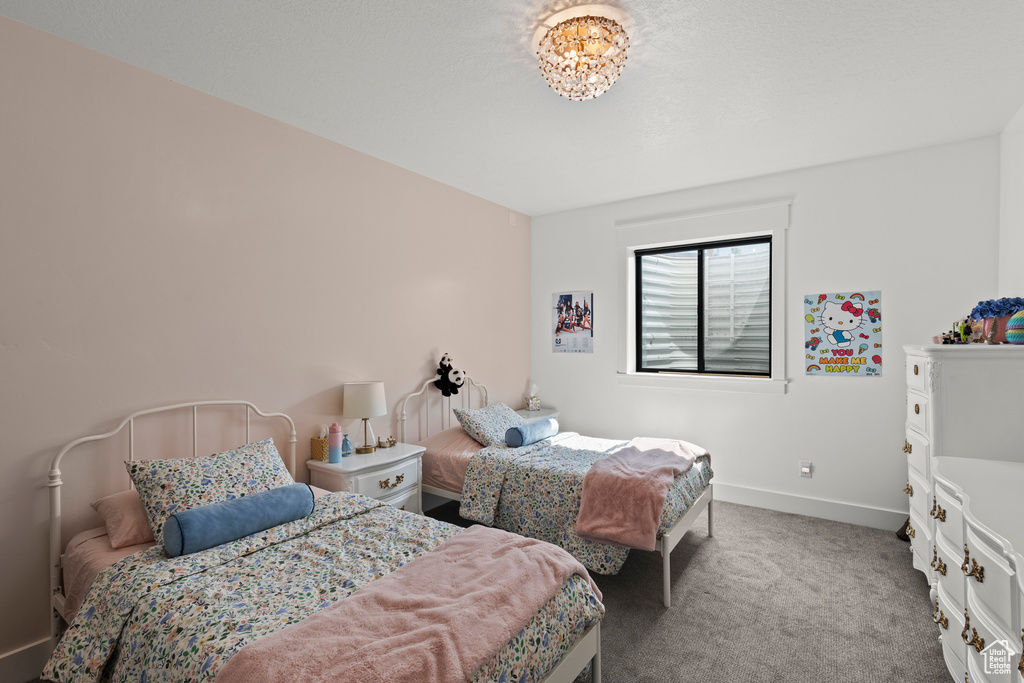 Carpeted bedroom featuring baseboards
