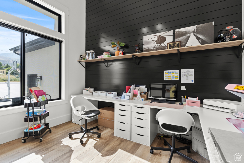Office with plenty of natural light and light wood finished floors