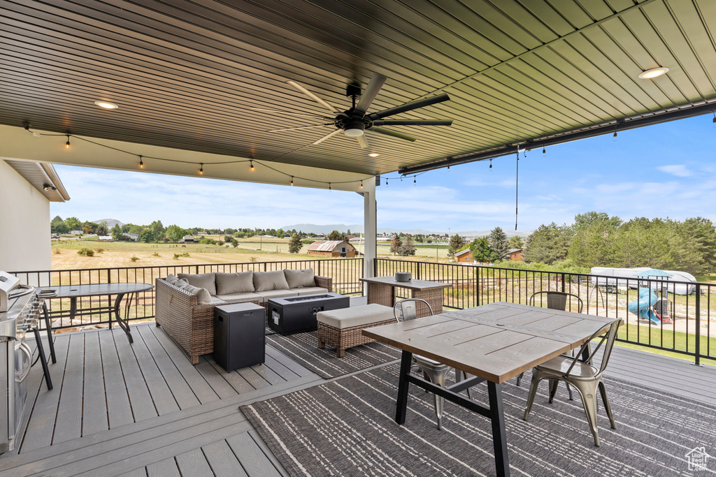 Deck with an outdoor hangout area, outdoor dining area, and ceiling fan