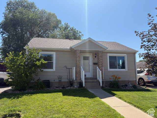 Bungalow-style home with a front yard