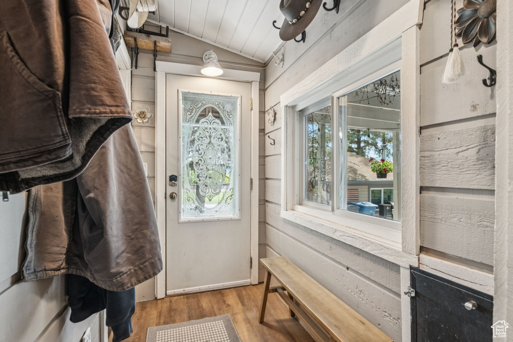 Doorway to outside with vaulted ceiling, wood finished floors, and wooden ceiling