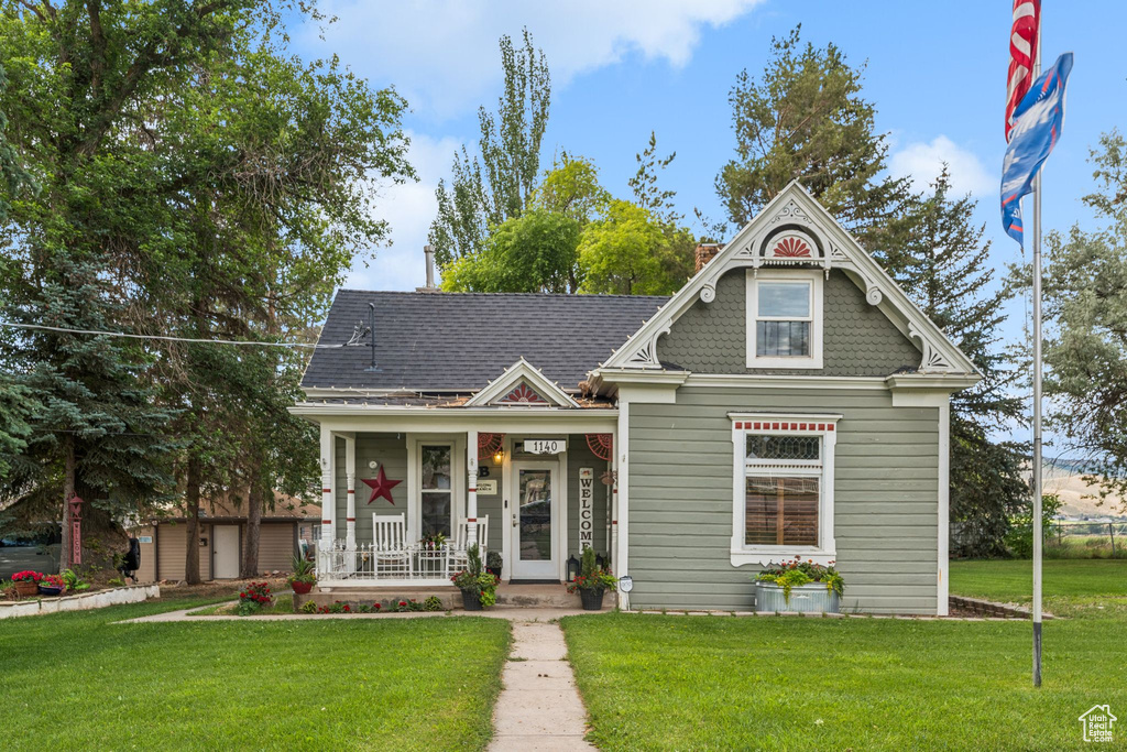 View of front facade featuring a porch and a front lawn