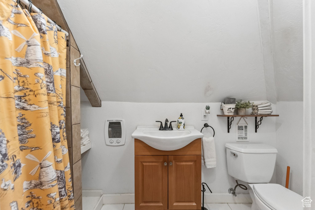 Bathroom with vanity, tile patterned floors, and a shower with shower curtain