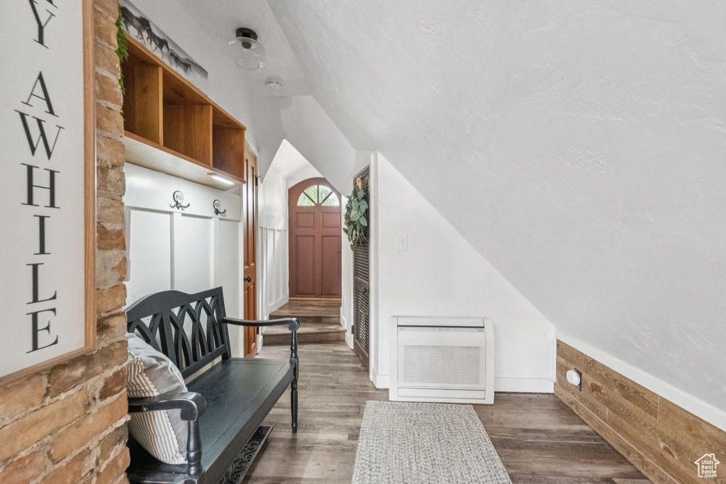 Sitting room featuring vaulted ceiling and wood finished floors