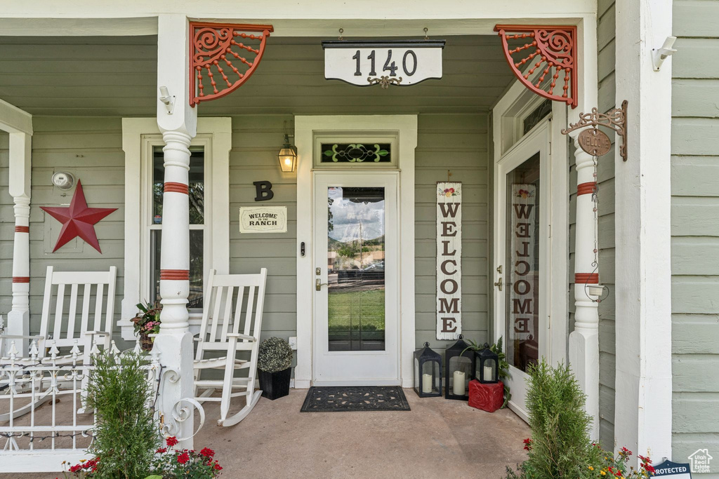 View of exterior entry with covered porch
