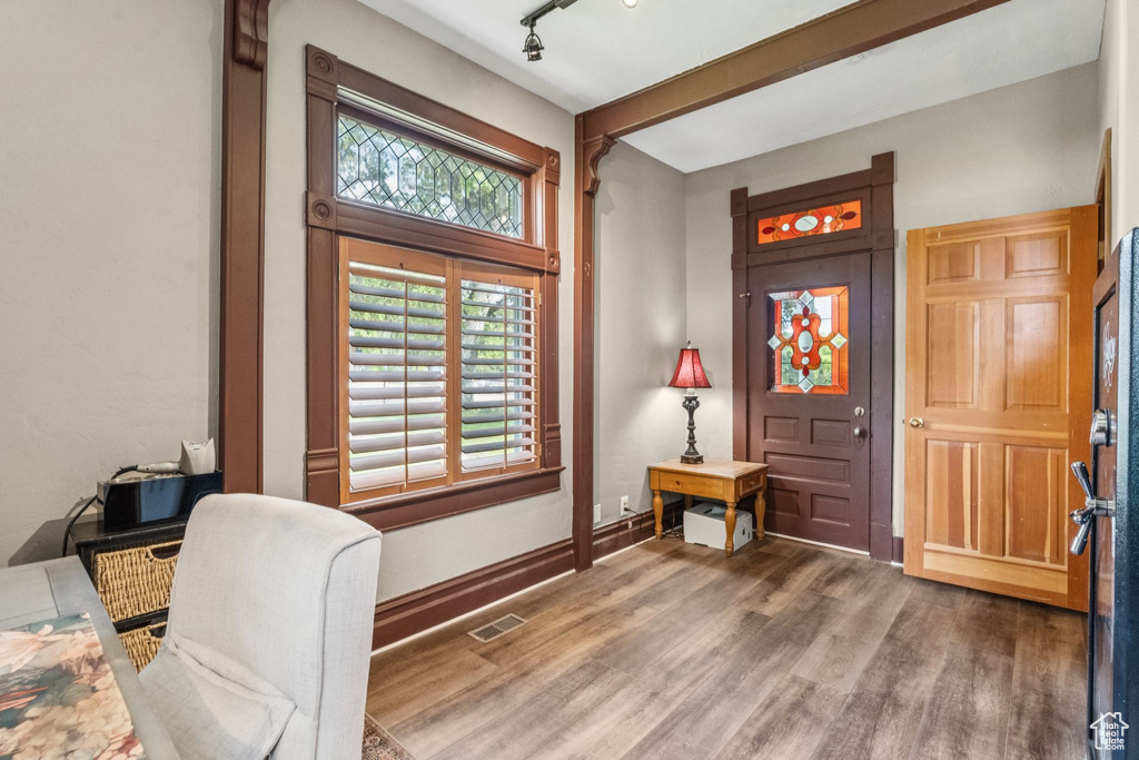 Foyer entrance with wood finished floors and rail lighting