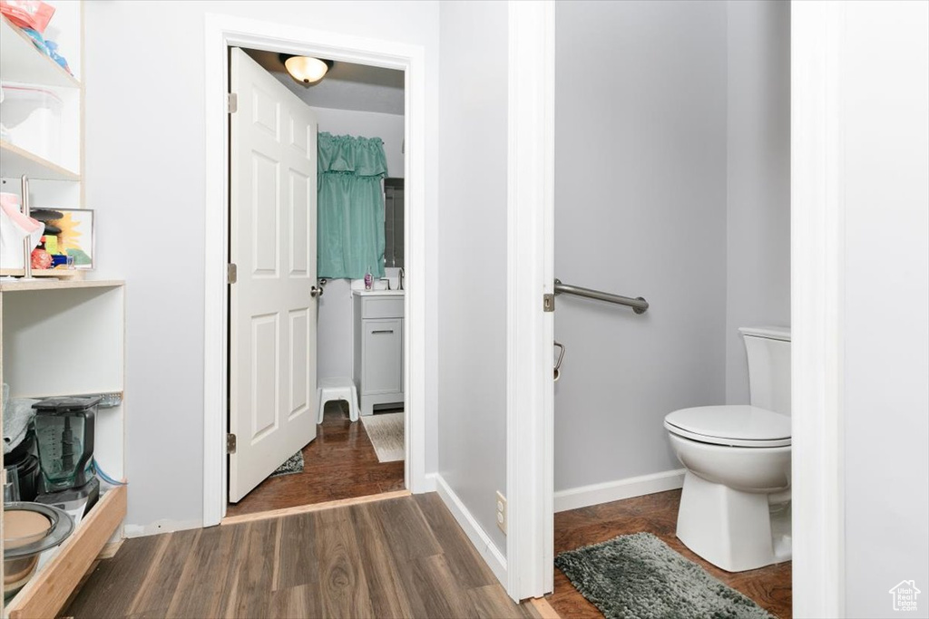 Bathroom featuring toilet and wood finished floors