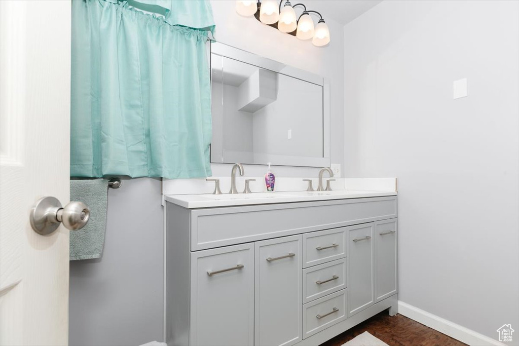 Bathroom with double vanity and baseboards