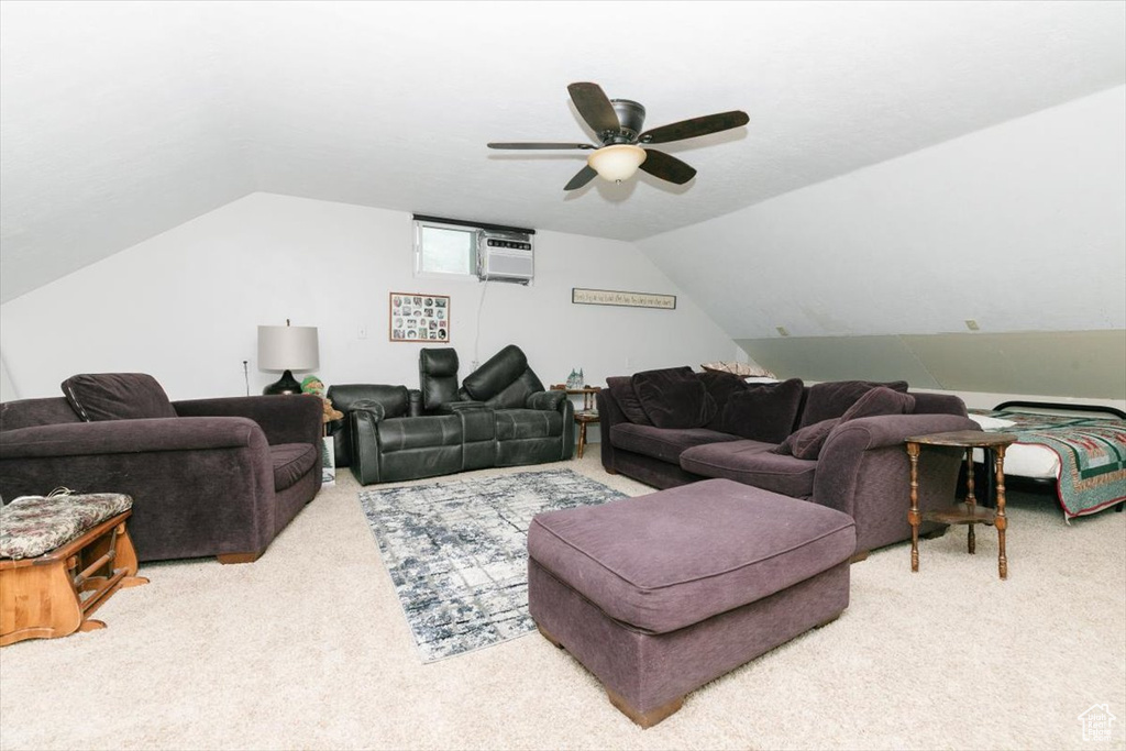Living room featuring carpet floors, a wall mounted AC, vaulted ceiling, and ceiling fan