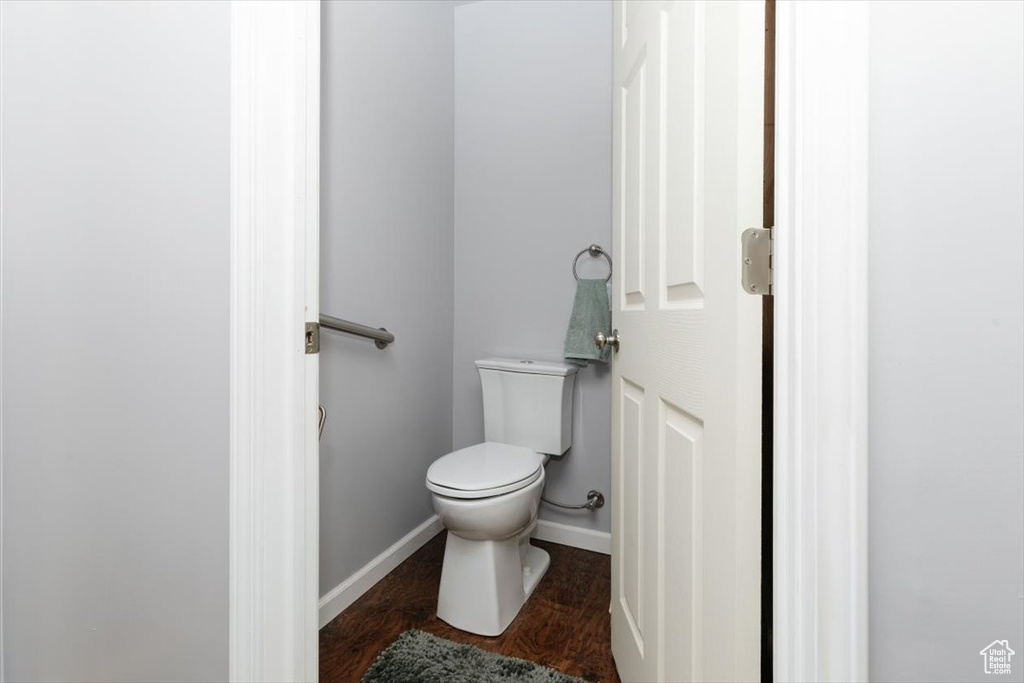 Bathroom featuring toilet and wood finished floors