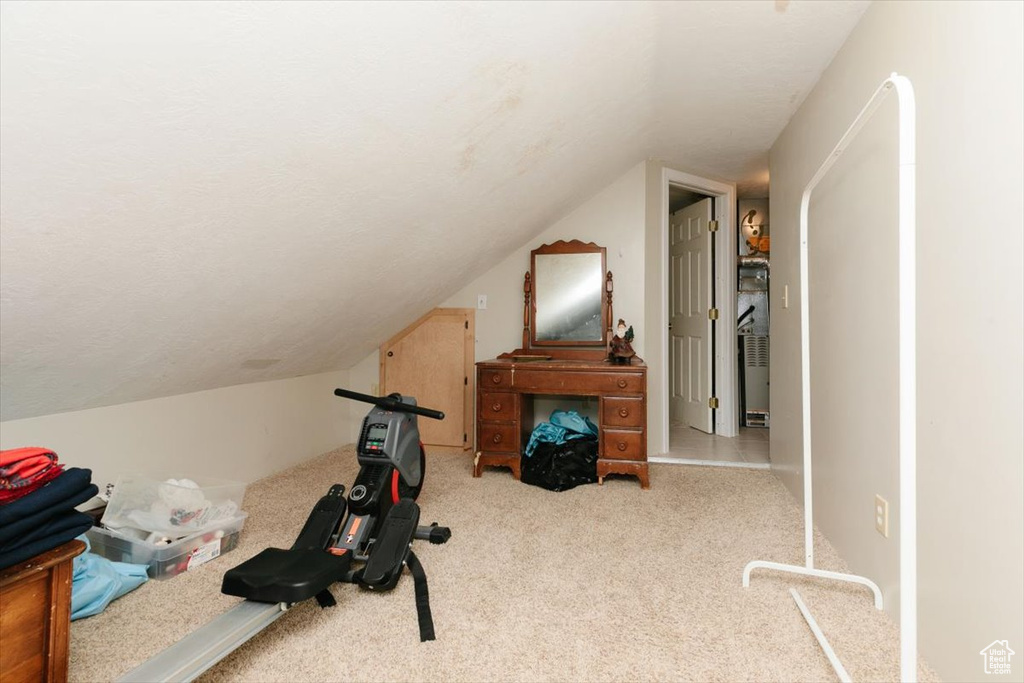 Exercise area with carpet floors and vaulted ceiling