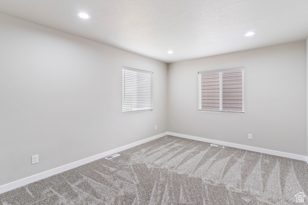Spare room featuring carpet flooring and recessed lighting