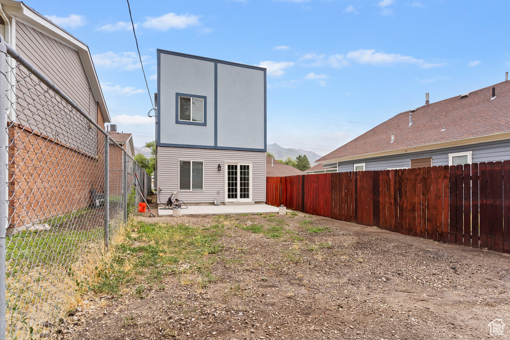 Rear view of property with a patio area and a fenced backyard