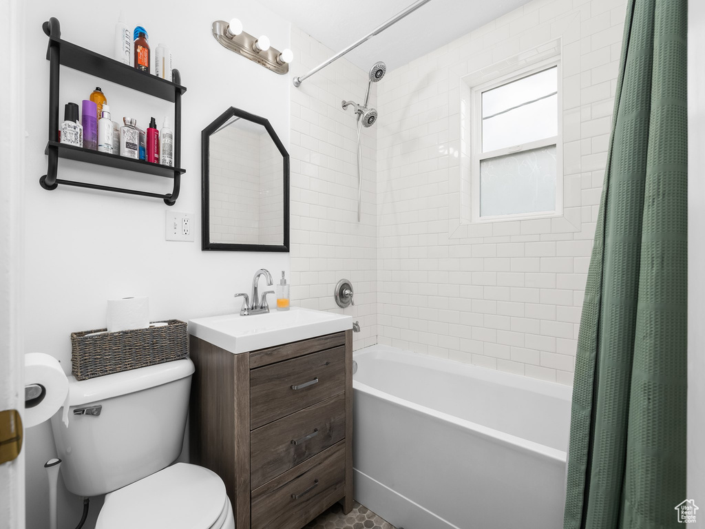 Full bath featuring shower / bath combo with shower curtain and vanity