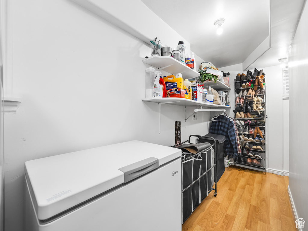 Walk in closet featuring light wood-style floors