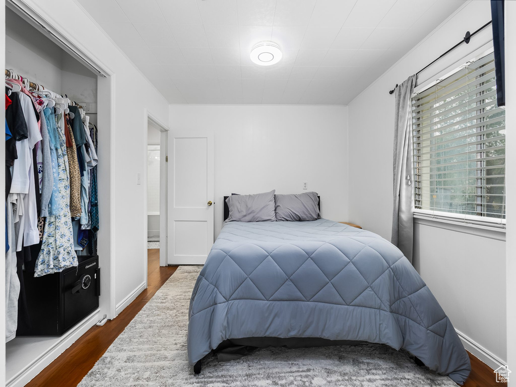 Bedroom featuring wood finished floors and a closet