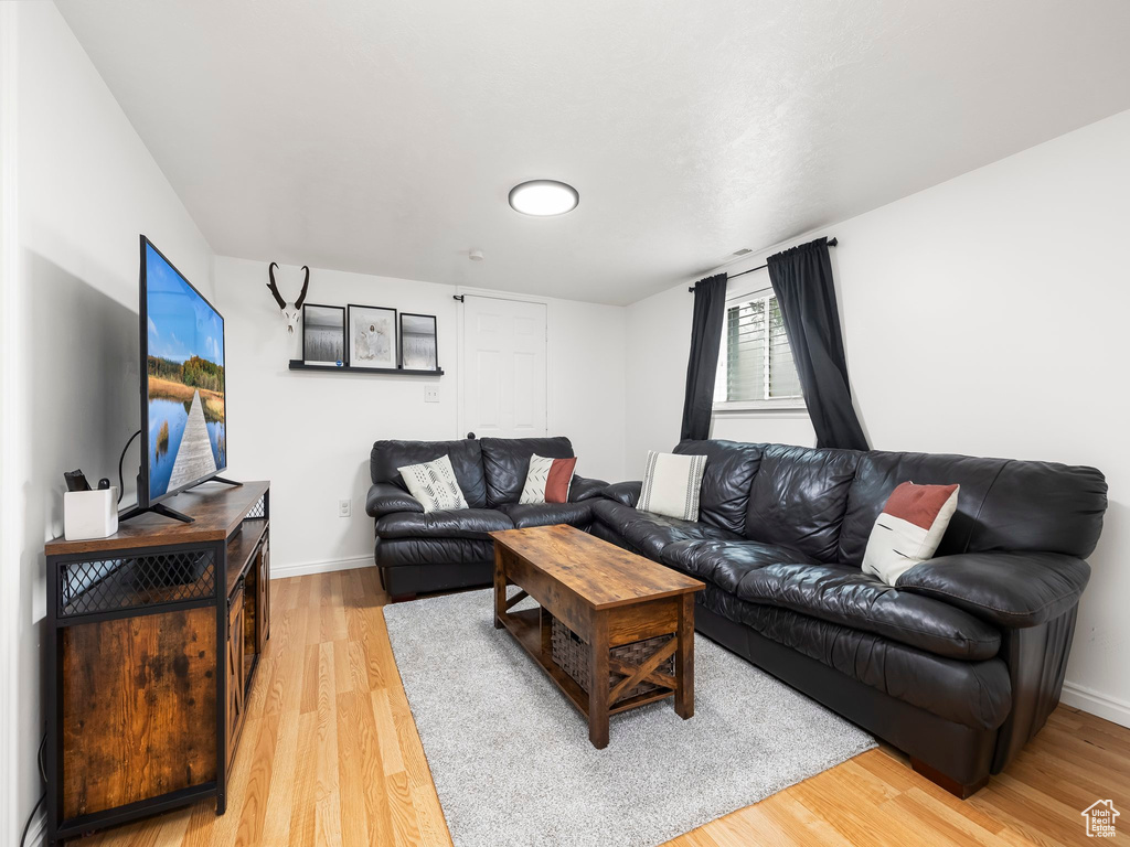 Living area featuring light wood-type flooring and baseboards