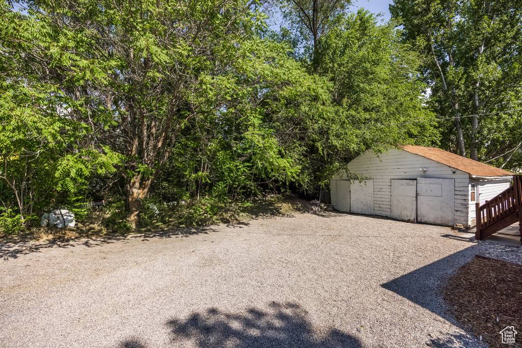 View of yard with a storage shed and a garage