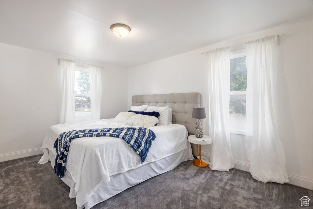 Bedroom with carpet floors and baseboards
