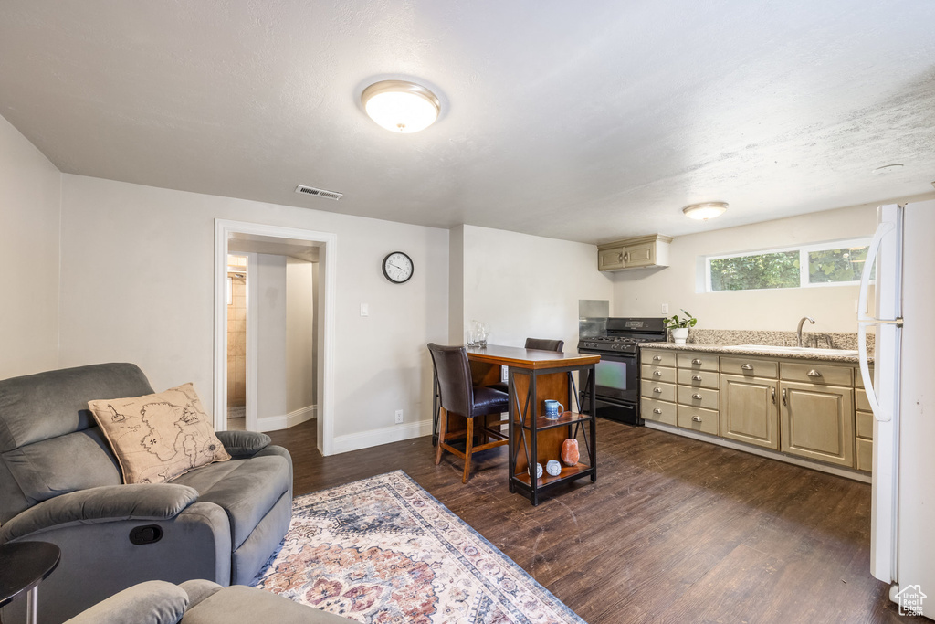 Living area with dark wood-style floors and baseboards