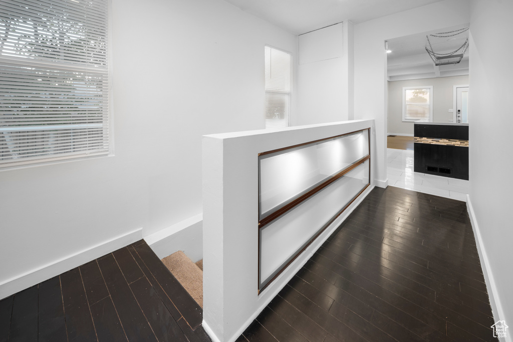 Corridor with hardwood / wood-style flooring