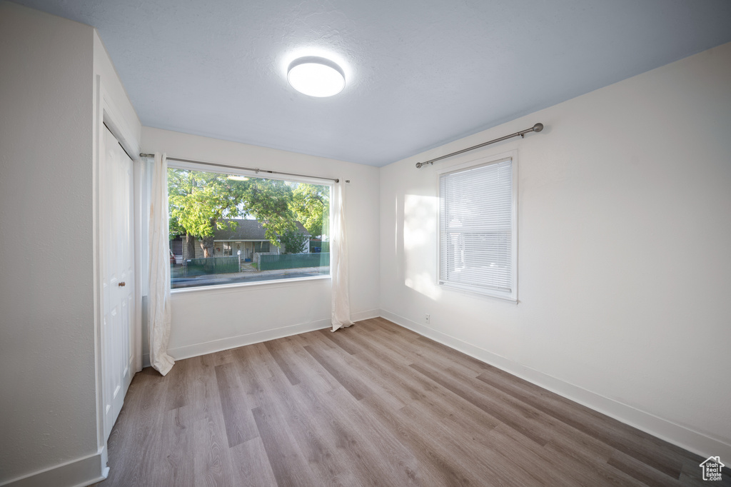 Unfurnished bedroom featuring wood finished floors and a closet