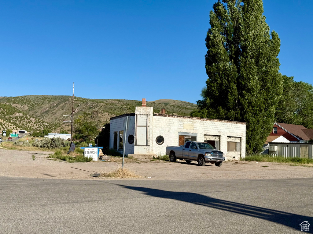 View of front of property featuring a mountain view and a chimney