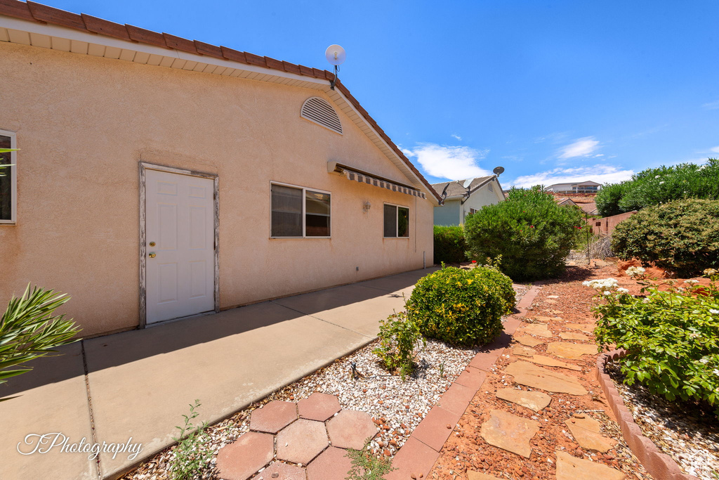 Rear view of property featuring stucco siding and a patio area