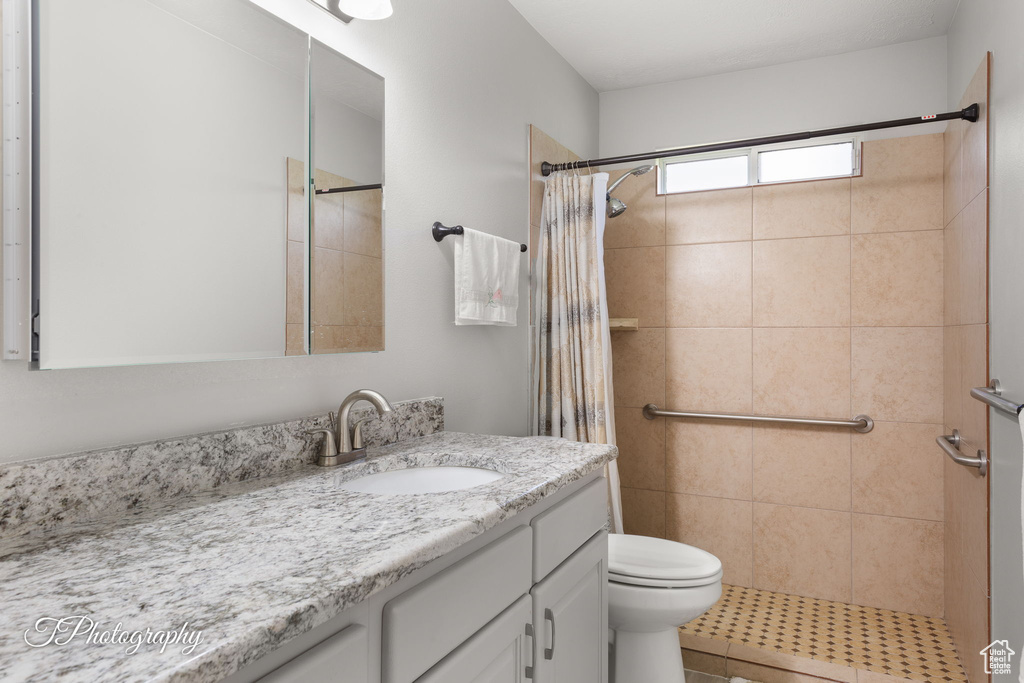 Bathroom with vanity and tiled shower