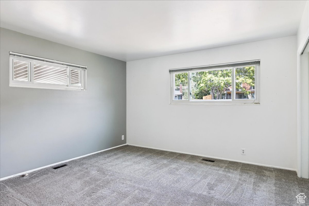 Empty room featuring carpet floors and baseboards