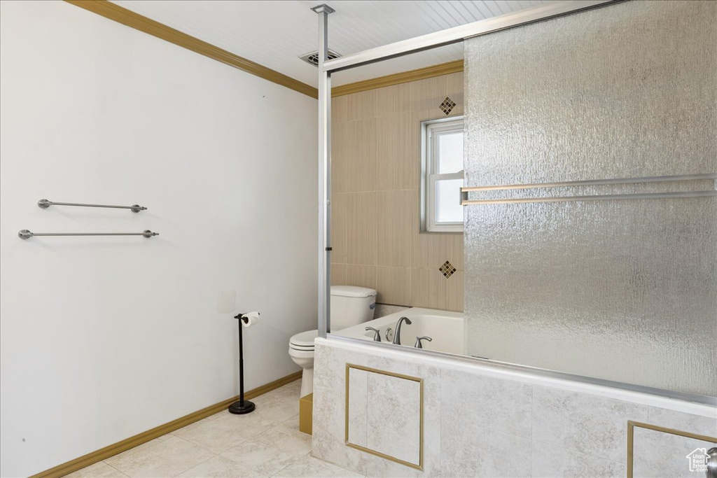 Full bathroom featuring a tub to relax in, ornamental molding, tile patterned flooring, and a shower