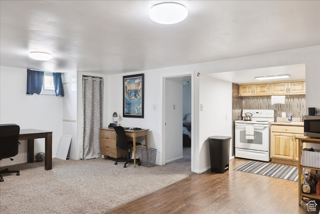 Office space with light wood-style floors and baseboards