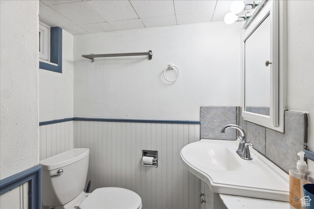 Half bathroom with vanity and wainscoting