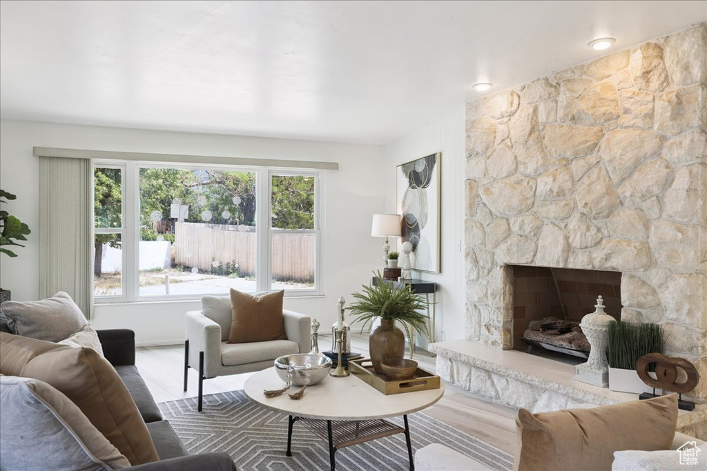 Living area featuring wood finished floors and a stone fireplace
