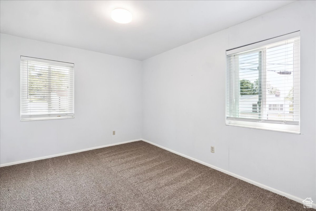 Empty room with carpet and baseboards
