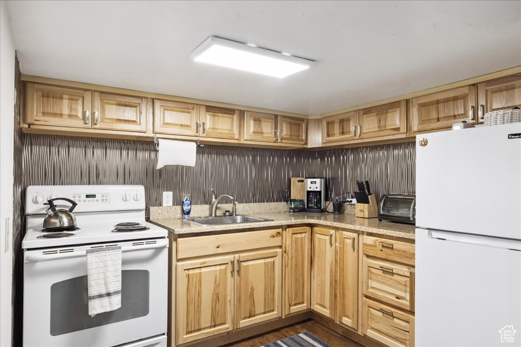 Kitchen featuring white appliances and light countertops