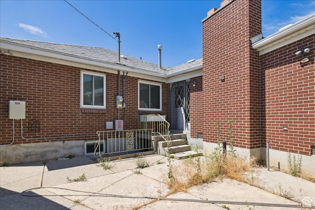 Entrance to property with brick siding