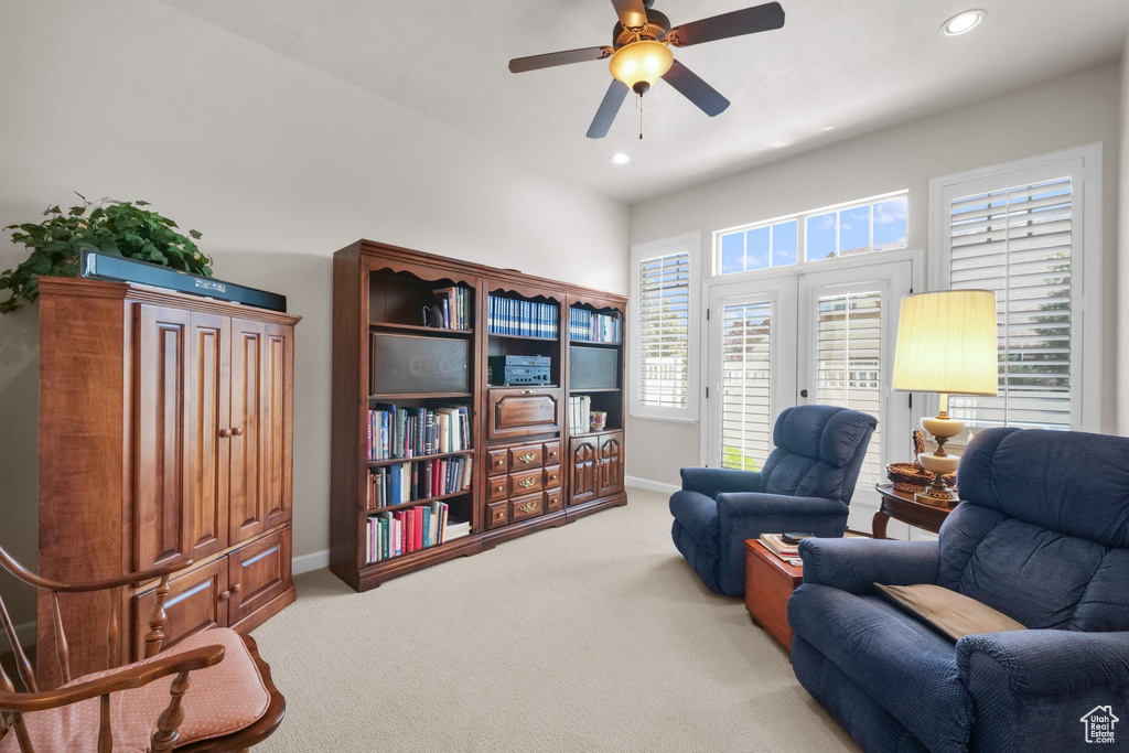 Living area featuring carpet, ceiling fan, and recessed lighting