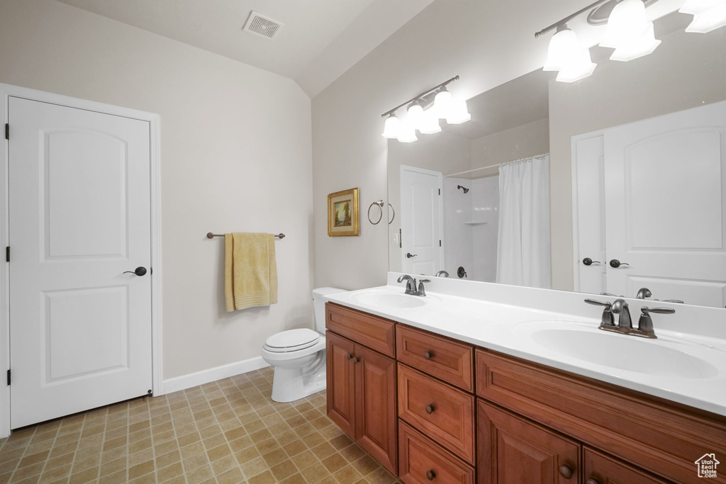 Full bath with double vanity and a shower with shower curtain