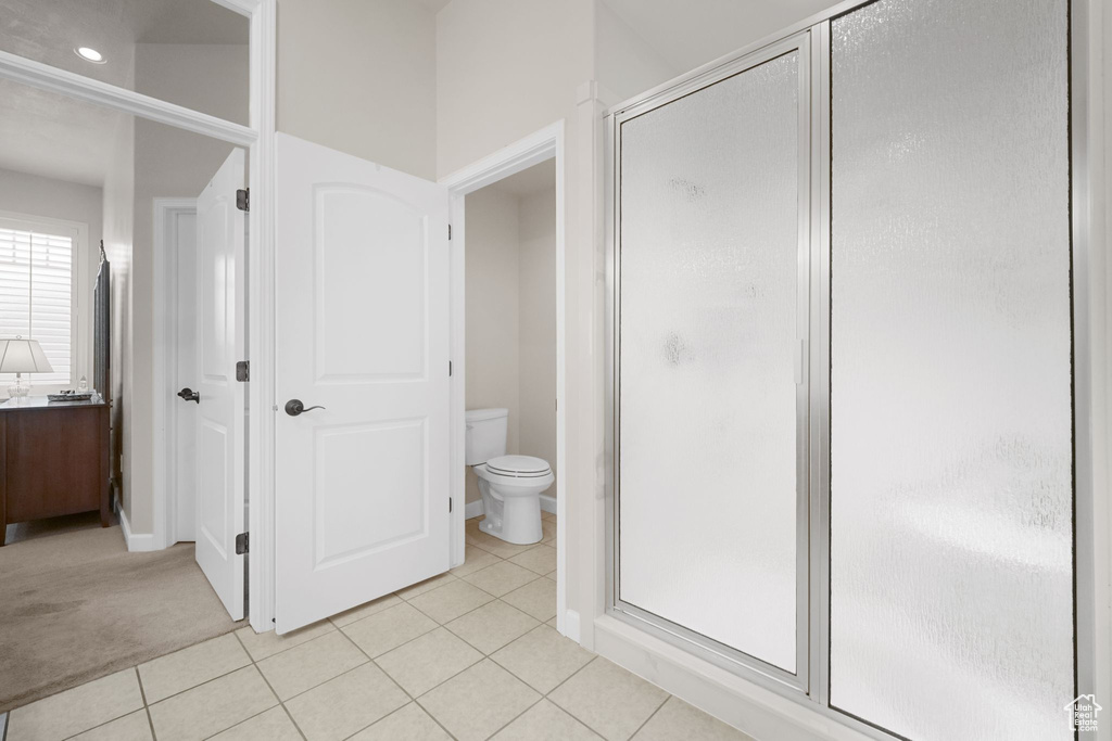 Bathroom with a stall shower, tile patterned floors, and vanity