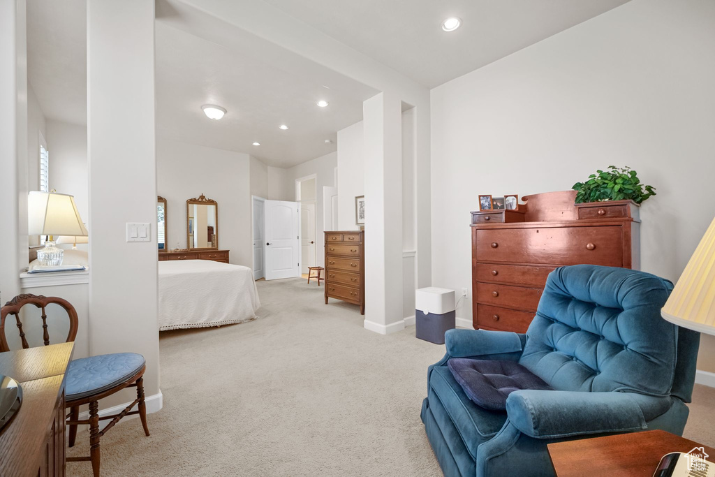 Bedroom with light colored carpet and recessed lighting