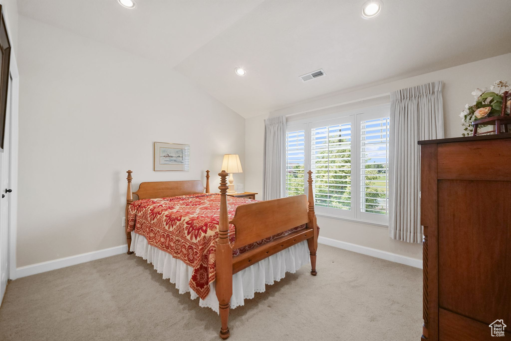 Bedroom featuring recessed lighting, vaulted ceiling, and light colored carpet
