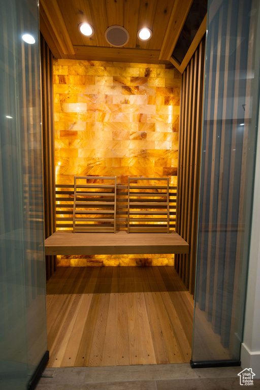 Relaxing sauna / steam room with wood finished floors and recessed lighting