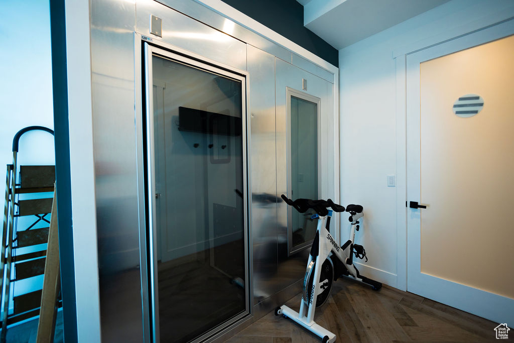 Workout room with dark wood-type flooring