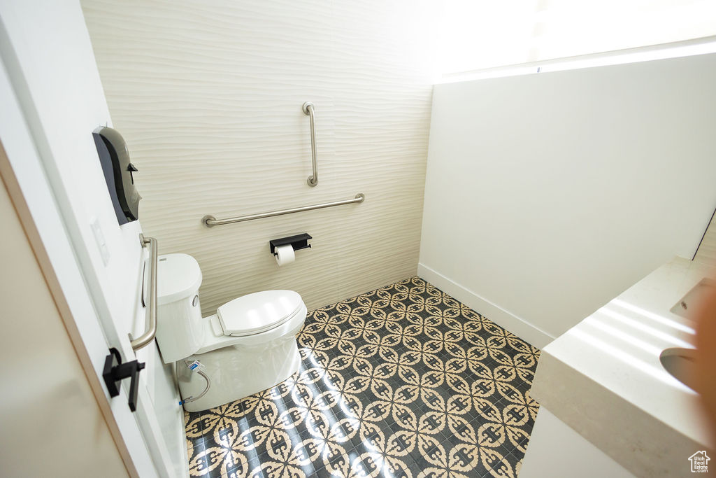 Bathroom with toilet and baseboards